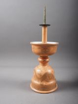A Chinese peach glazed pricket candlestick with gilt dragon and wave decoration, 11 1/2" high