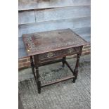 An 18th century provincial carved oak side table, fitted one drawer, on turned and stretchered