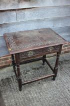 An 18th century provincial carved oak side table, fitted one drawer, on turned and stretchered