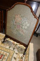 A 1920s walnut framed fire screen with embroidered panel, 20" wide