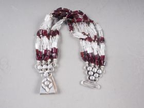 A white metal, stamped 925, rock crystal and garnet bead bracelet