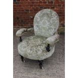 A Victorian low showframe occasional open armchair, upholstered in a cut velour, on turned supports