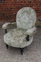 A Victorian low showframe occasional open armchair, upholstered in a cut velour, on turned supports