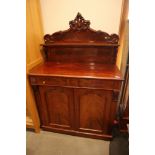 A late 19th century figured mahogany ledge back chiffonier, fitted shelf over two drawers and