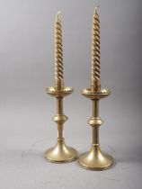 A pair of gothic style turned brass candlesticks, on circular bases, 8 1/4" high, a painted cast