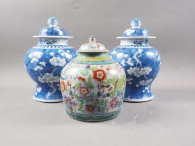 A pair of blue and white ginger jars and covers, 10" high, and a clobbered ginger jar and cover,