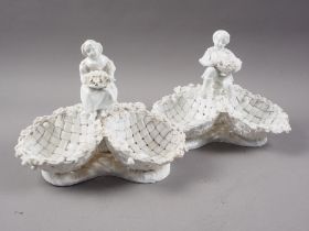 A pair of late 18th century Meissen blanc-de-chine dishes, formed as baskets with child finials,