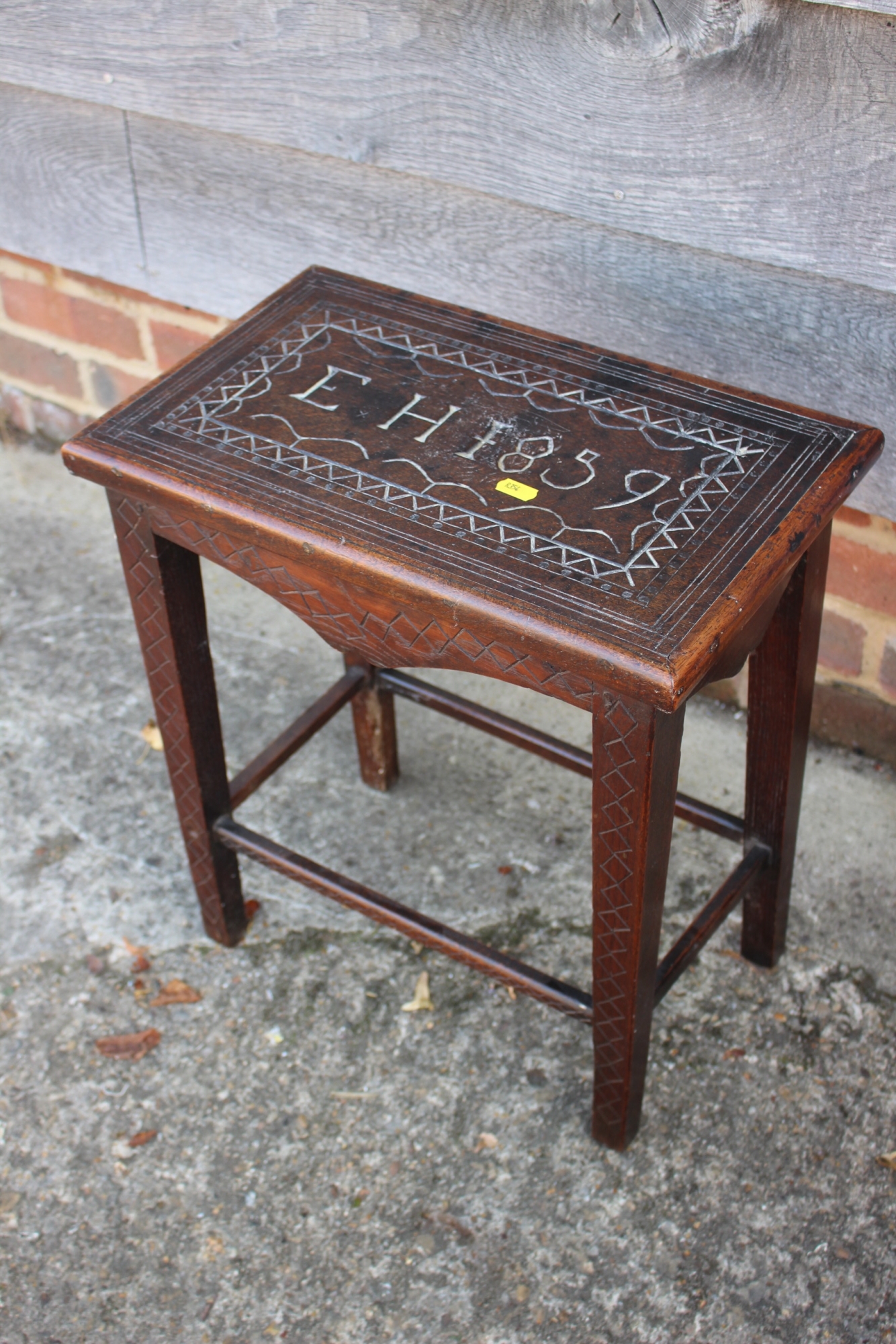 A 19th century carved oak stool/occasional table, on square taper supports, inscribed EH 1859, 17"