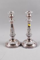 A pair of silver plate on copper candlesticks with embossed decoration, 12" high