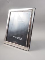 A modern silver photograph frame, 9 1/4" high