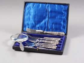 A silver mounted magnifying glass, six silver handled pastry forks, a silver handled butter knife,