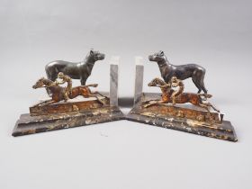 A pair of early 19th century brass racehorse implement rests, 9" wide, and a pair of spelter and
