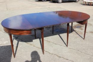 A Regency mahogany extending dining table with reeded edge, and extra leaf, on eight turned and