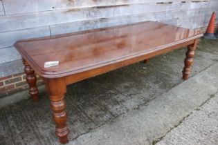 A cherrywood dining table, on turned supports, 88" wide x 42" deep x 29" high