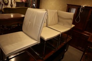 A set of four "Cattelan Italia" cream leather dining chairs, on chrome supports