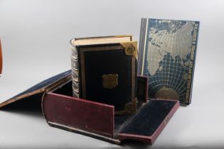 A late 19th century "Family Bible" with gilt clasps, in original velvet lined box, and a world atlas