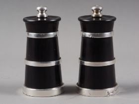 A pair of ebonised and silver mounted salt and pepper grinders