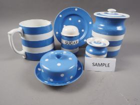 A T G Green Cornishware blue and white banded sugar dredger, a similar polka dot decorated butter