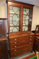 A Georgian mahogany satinwood box and ebony strung secretaire bookcase, the upper section enclosed