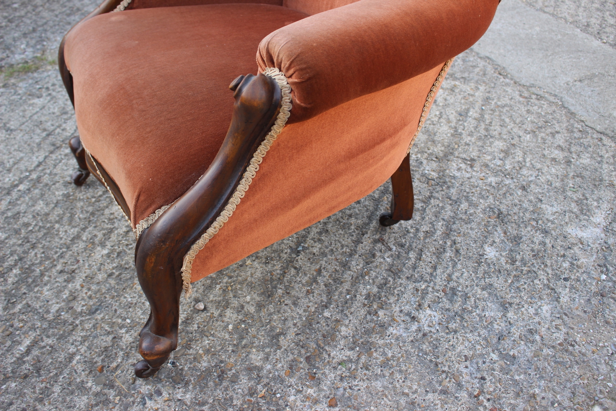 A Victorian carved walnut showframe armchair, upholstered in a rust velour, on cabriole supports - Image 2 of 2