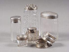 Three cut glass and silver mounted dressing table jars, a silver topped inkwell, a cut glass and