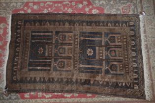 A tribal prayer rug with architectural design in shades of red, blue, black and natural, 55" x 32"