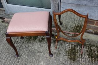 A mahogany dressing stool with drop-in seat, on cabriole supports, 19" wide, and a shield-shaped