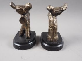 A pair of bronzed bookends, formed as doves on branches, on ebonised plinth bases, 7" high