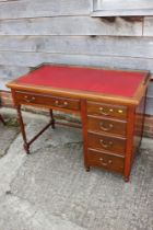 An Edwardian walnut single pedestal desk with tooled lined top, fitted three drawers, 42" wide x 23"