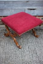 An early 19th century carved walnut 'X' frame stool, upholstered in a red velour, 22" square x 8"