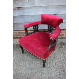 A Victorian chair with ebonised splat back, upholstered in a red velour, on cabriole supports