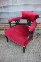 A Victorian chair with ebonised splat back, upholstered in a red velour, on cabriole supports