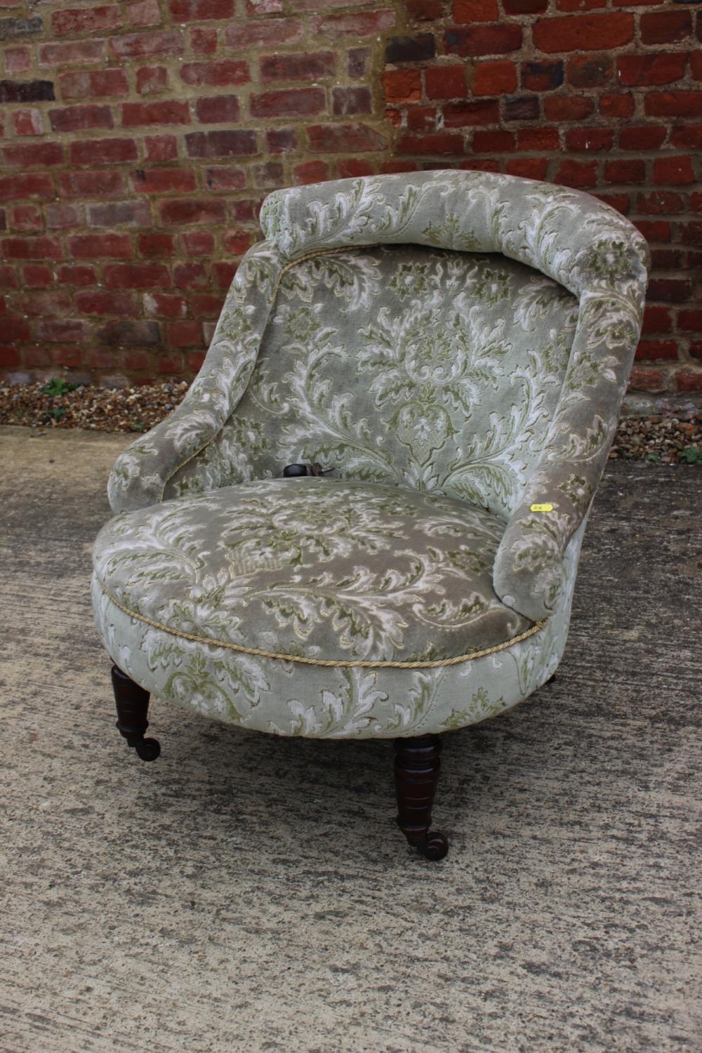 A Victorian low tub seat chair, button upholstered in a cut velour, on turned supports