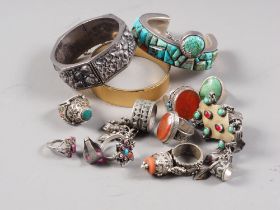 A tribal white metal bangle, set turquoise, a similar fruit embossed bangle and a number of white