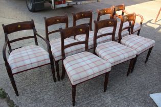 A set of eight early 19th century mahogany bar back dining chairs with stuffed over seats,