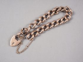 A 9ct gold curb link bracelet with engraved hollow links and heart shaped clasp, 16.4g