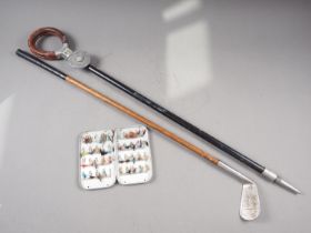 A hickory shafted golf club, a shooting stick and a Wheatley alloy fly tin, containing a selection