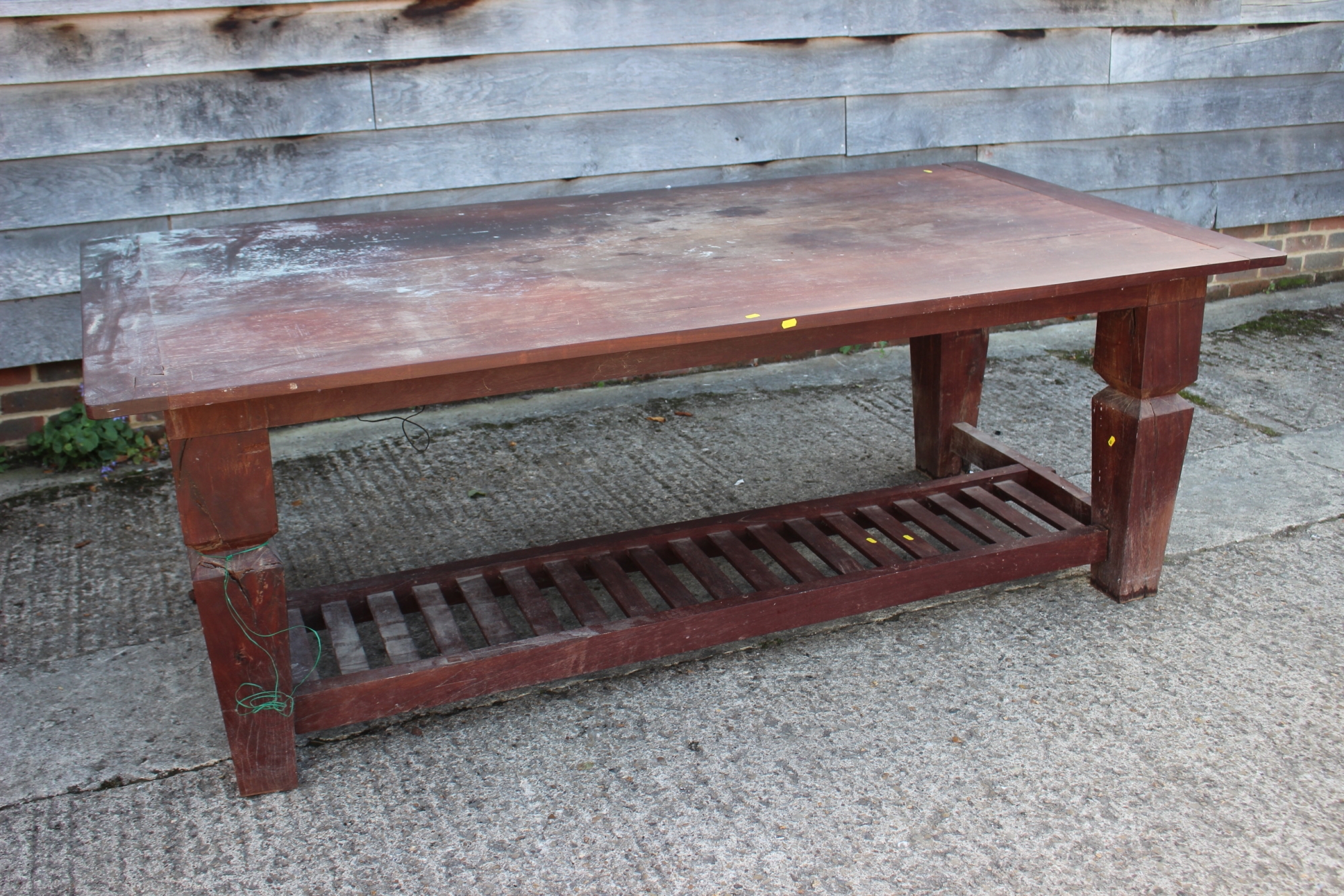 An Acacia plank top desk/writing table, on square taper supports united by a slatted undertier,