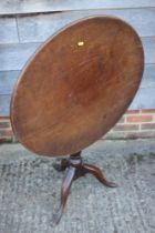 An early 19th century mahogany circular tilt top occasional table, on turned column and tripod splay