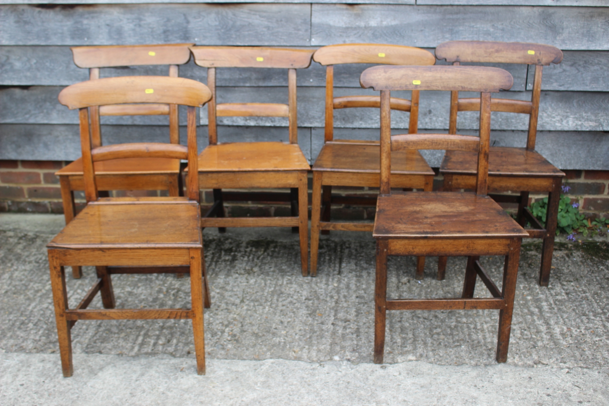 A Harlequin set of six 19th century oak bar back dining chairs with panel seats and stretchered