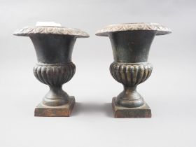 A pair of bronzed Campana vases, on square bases, 9" high