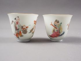 A pair of Chinese porcelain wine cups each decorated four figures, seal mark to base, 2" high