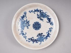 A Chinese crackle glaze shallow dish, decorated in underglaze blue with floral motifs, 8 1/2" dia