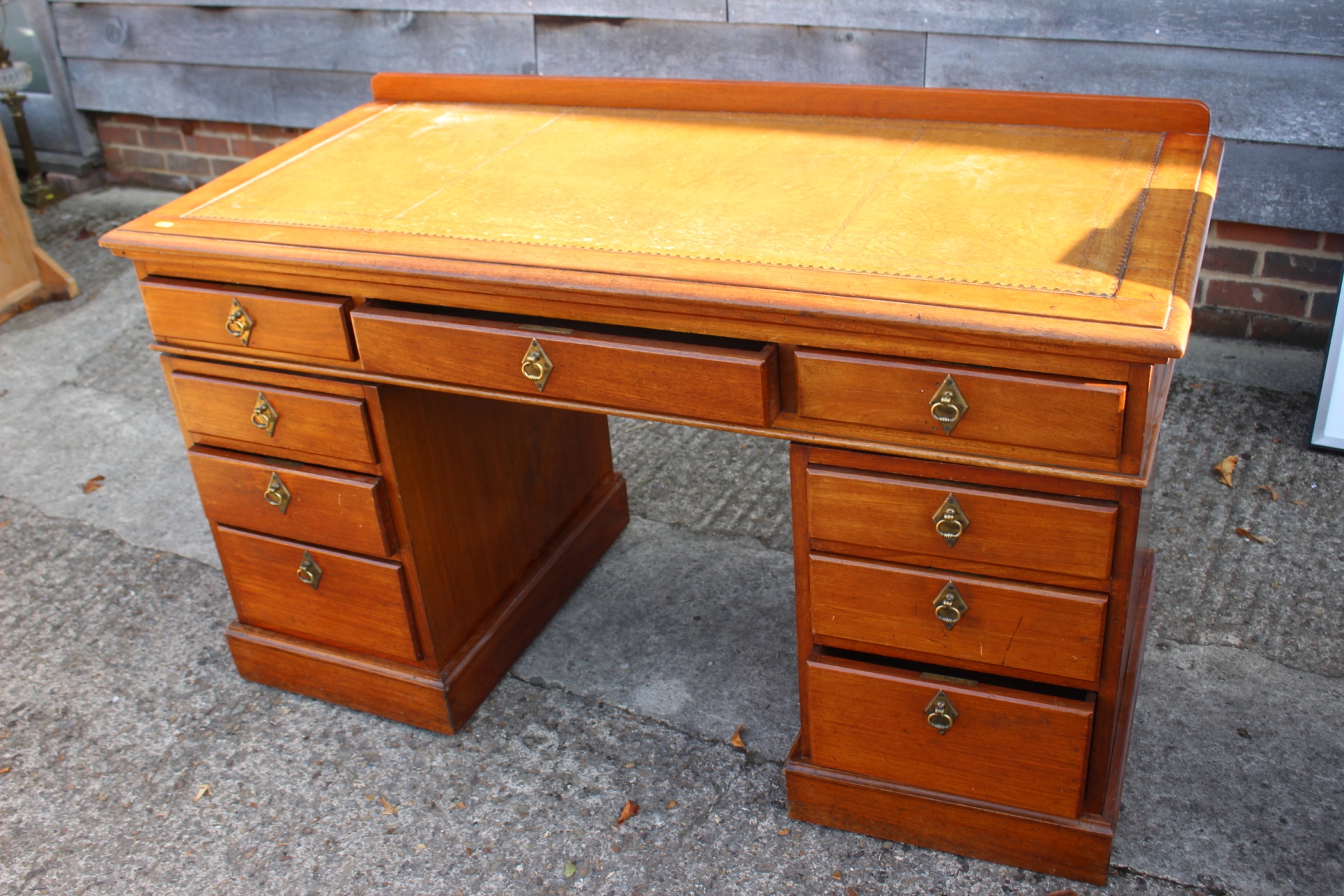 A late 19th century mahogany double pedestal desk with tooled leather top over nine drawers, 52"