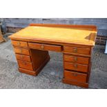 A late 19th century mahogany double pedestal desk with tooled leather top over nine drawers, 52"