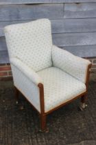 An Edwardian mahogany and inlaid showframe armchair, upholstered in a floral tapestry, on square