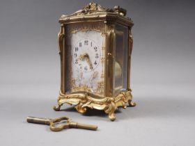 A late 19th century French bronze and bevelled glass repeating carriage clock with enamelled dial,