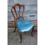 A 19th century carved mahogany shape back side chair and a child's deportment/high chair