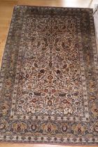 A Kashan silk rug with all-over foliate scroll design and multi boarders in shades of blue, cream,