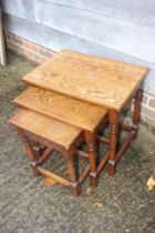 A nest of three oak occasional tables, on turned and stretchered supports, largest 20" wide x 14"